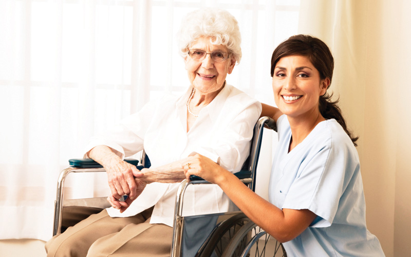 caregiver with elderly senior women home from the hospital