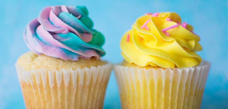 cupcakes with frosting on blue wall