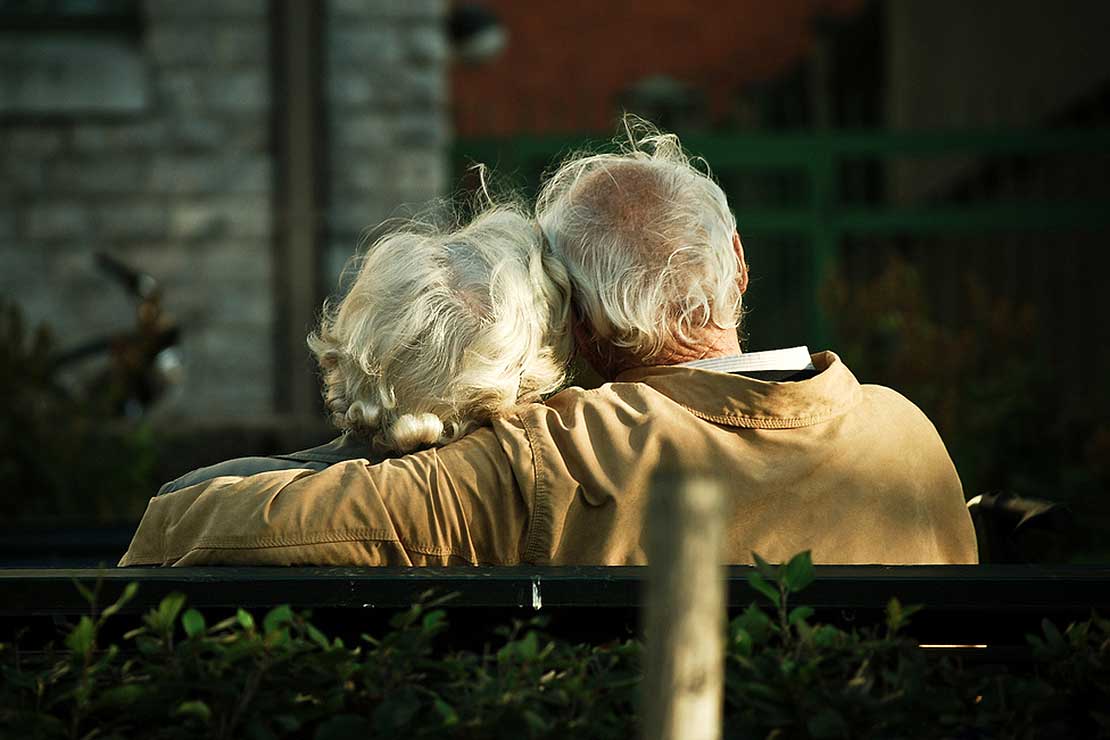 eldery on a bench in a relationship with dementia